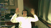 a man wearing headphones and glasses is dancing in front of a screen that says raid water raid and others