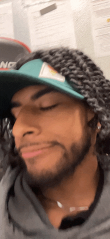 a close up of a man wearing a hat with the word nz on it