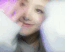 a blurry picture of a woman 's face with a purple and white background