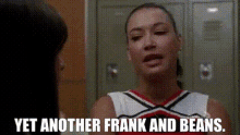 a cheerleader is talking to another cheerleader in a locker room and says yet another frank and beans .