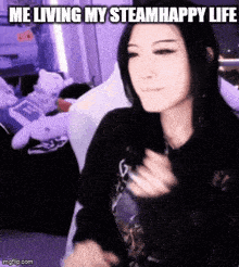 a woman is sitting on a couch and making a funny face with the words `` me living my steamhappy life '' .