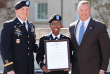 a woman in a military uniform is holding a framed certificate that says ' united states army '