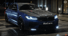 a blue bmw with the word rocars on the side