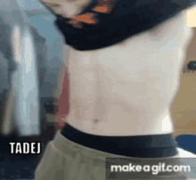 a man without a shirt is standing in front of a make a gif.com screen