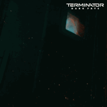 a poster for terminator dark fate shows a man holding a robotic arm