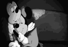 mickey mouse and minnie mouse hugging each other in a black and white cartoon