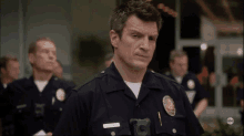 a man in a police uniform has a name tag that says castle