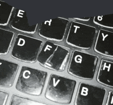 a close up of a keyboard with the letters e h t y d f g h c v b