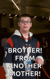 a young man with glasses and a name tag that says brother from another mother .