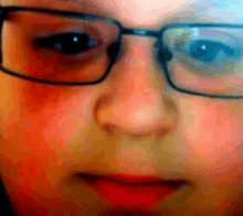 a close up of a person 's face wearing glasses .