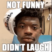 a man wearing a white hat with the words not funny did n't laugh on it