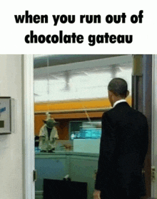 a man in a suit is walking out of a chocolate cake