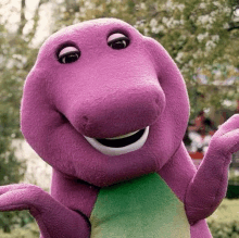 a close up of a purple dinosaur mascot with a green tail .