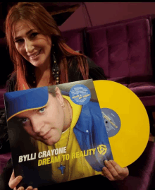 a woman holds a bylli crayone dream to reality record