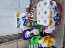 a stack of scott toilet paper sits next to a stack of laundry detergent