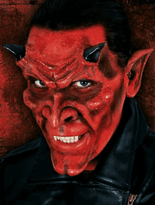 a man with red face paint and horns on his face