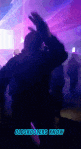 a man dancing in a club with the words oldskoolers know below him