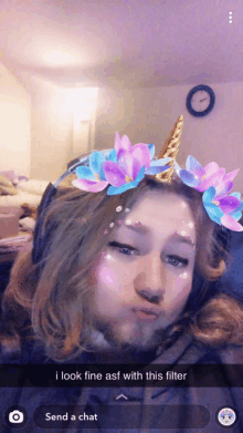 a girl with a unicorn headband and flowers on her face