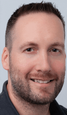 a close up of a man 's face with a beard