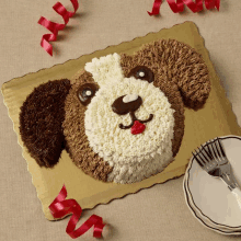 a cake in the shape of a dog 's head with a fork