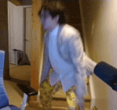 a man in a suit is walking down stairs