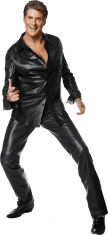 a man in a black leather suit is giving a thumbs up sign