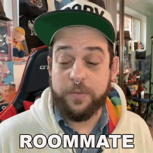 a man with a beard is wearing a hat that says roommate on it