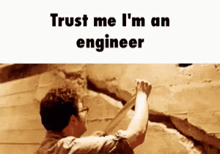 a man is climbing up a wall with the words trust me i 'm an engineer