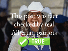 a woman wearing a white cowboy hat and a blue vest with albertan patriots written on the bottom