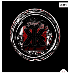 a black circle with a red square in the middle and the letter xk on it