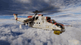 a white and red helicopter is flying through the clouds ..