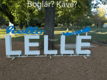 a sign that says hello lelle is in a park