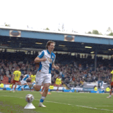 a soccer player wearing a blue and white jersey with the word bwin on the front