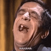 a man is making a funny face with his mouth open and a tooth missing .