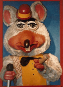 a chuck e cheese holding a microphone and a cigar