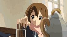 a girl with a scarf around her neck is holding chopsticks in front of a tea kettle