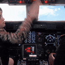 a man and a woman are sitting in the cockpit of an airplane with a screen that says low fuel