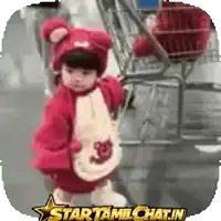 a baby in a teddy bear costume is being pushed in a shopping cart by a star tamilchat.in sticker