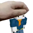 a hand is holding a minecraft character with a blue shirt and orange tie .