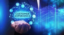 a man in a suit is holding a circle with the words `` customer experience '' on it .