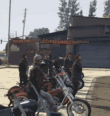 a group of motorcycles are parked in front of a building that says hooded ph4avlesser ace