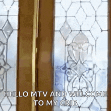 a stained glass door with the words hello mtv and welcome to my crib