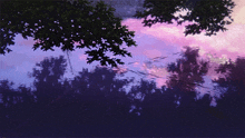 a purple sky with trees in the foreground and a few wires in the background