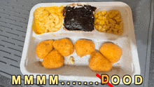 a styrofoam tray with nuggets mac and cheese corn and gravy