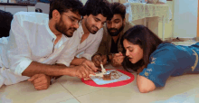 a group of people are laying on the floor eating food