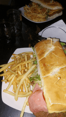 a sandwich and french fries are on a plate