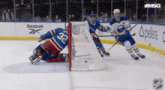 a hockey game is being played in front of a reebok sign