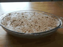 a casserole dish filled with a creamy dessert with nuts on top