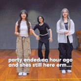 a group of three women are dancing together on a wooden floor .