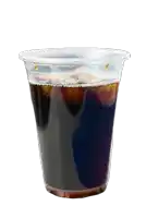a clear plastic cup filled with dark liquid